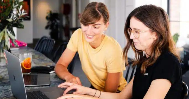 Two women working together on PC