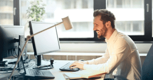 A young man looking at the computer screen working