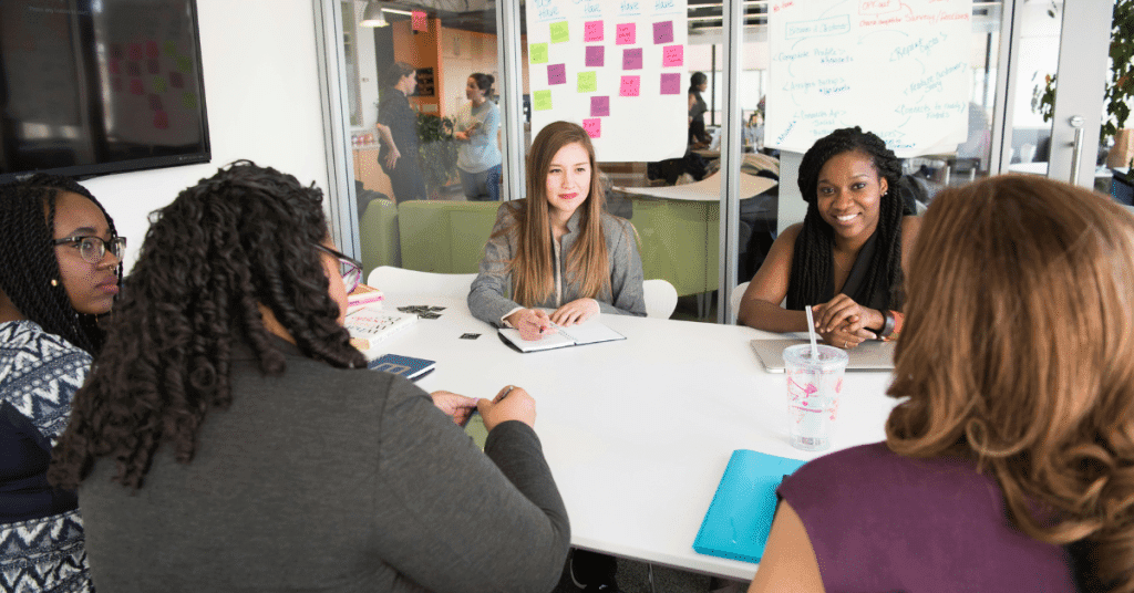 A group of five women having a meeting