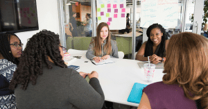A group of five women having a meeting