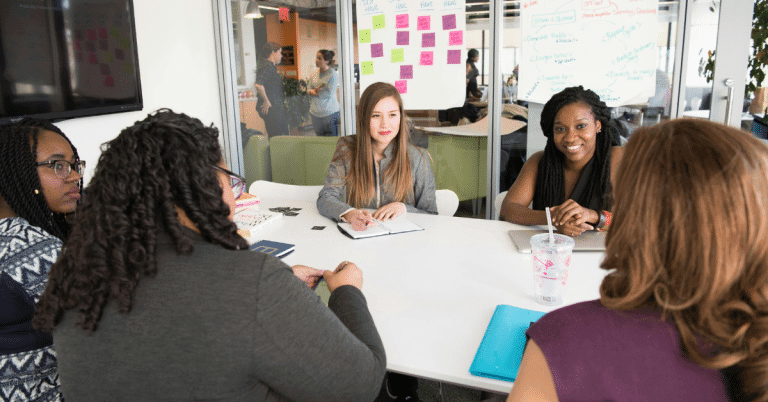 A group of five women having a meeting